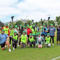 Experience Gaelic Games group in a field with hurleys