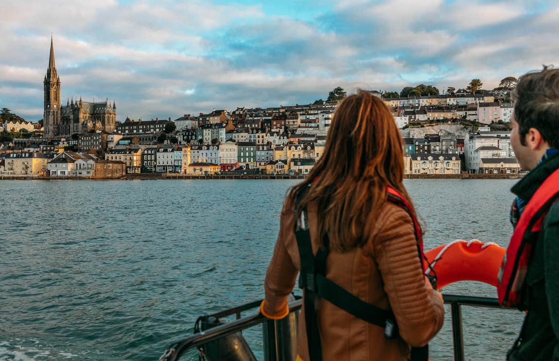 A couple looking out at Cobh in County Cork from a boat