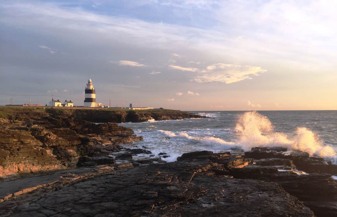 Sunset at Hook Head in Wexford with a lighthouse in the distance