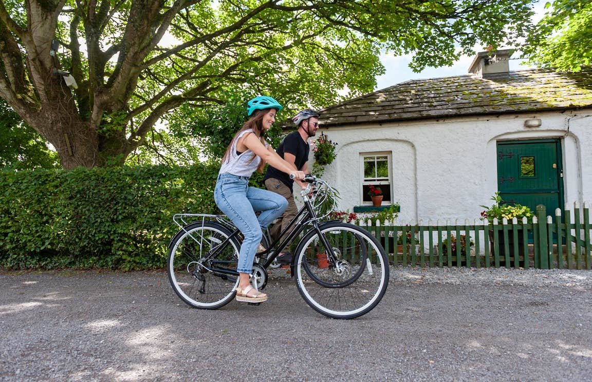 Couple cycling along the Royal Canal Greenway.