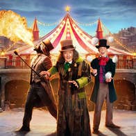 Scrooge: A Cirque Spectacular at Gleneagle, 3 performers in different costumes with hats, with roof of circus tent behind in winter with snow on the ground.