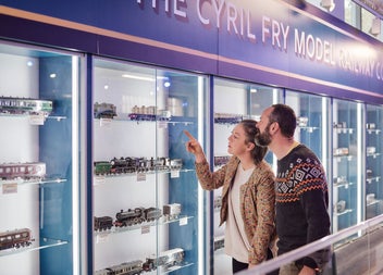 A couple looking at the displays of the model trains