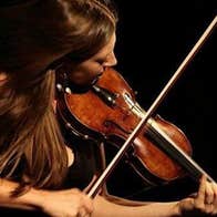 A woman playing a fiddle.