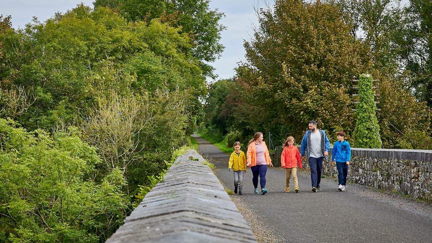 A family walking the Waterford Greenway