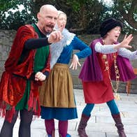 Bloomsday for Kids: The Cat and the Devil - 3 people in colourful costumes performing in a paved area.