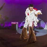 0800 Cupid _ Emer Dineen _ Thisispopbaby - a person performing on a stage in a fancy, white Elvis costume