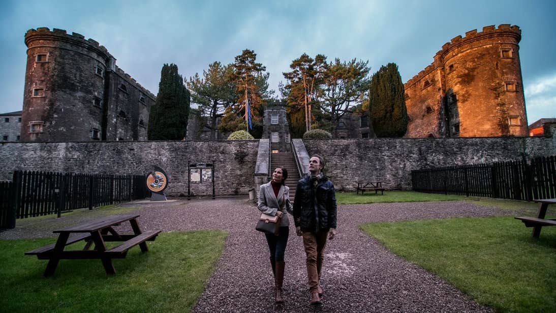 Couple walking through Cork City Gaol 