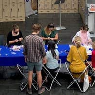 Drop-in for Families: Bealtaine Celebration, a long table with children and adults making things.