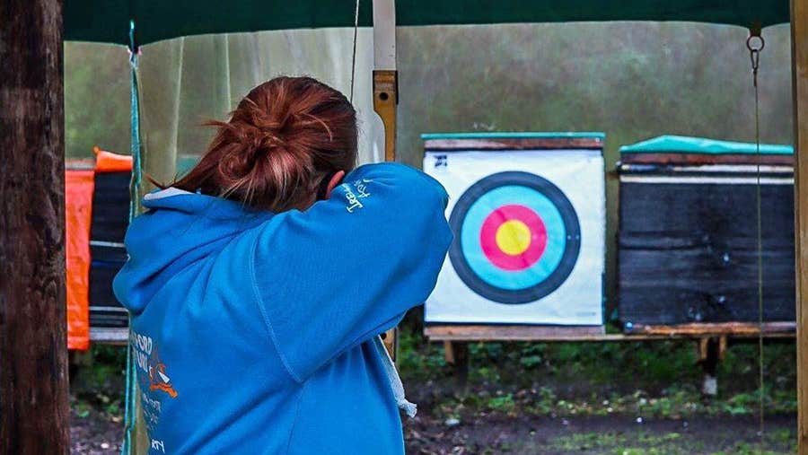 A person aiming at an archery target at Skypark in Carlingford