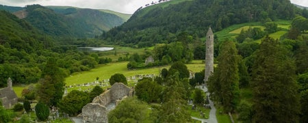 An aerial view of an ancient church and round tower