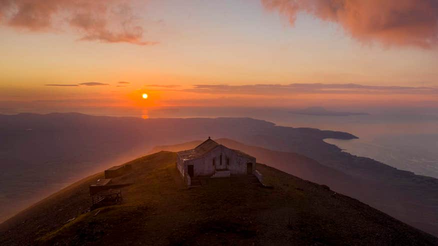 Dramatic view of Croagh Patrick summit at sunset.