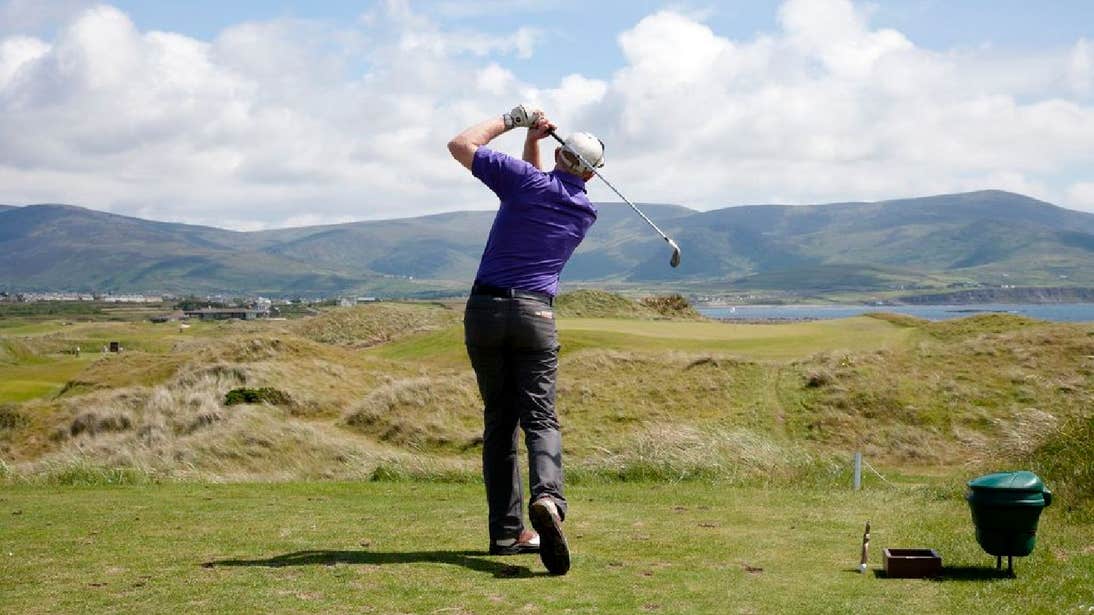 Man playing golf with mountains in the background Waterville Golf Links County Kerry