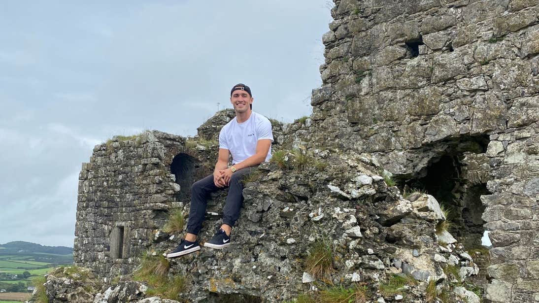 Greg O'Shea sitting on ruins at the Rock of Dunamase, Laois
