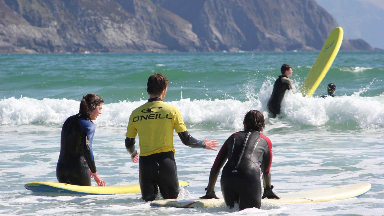 People surfing with their surf boards in the water