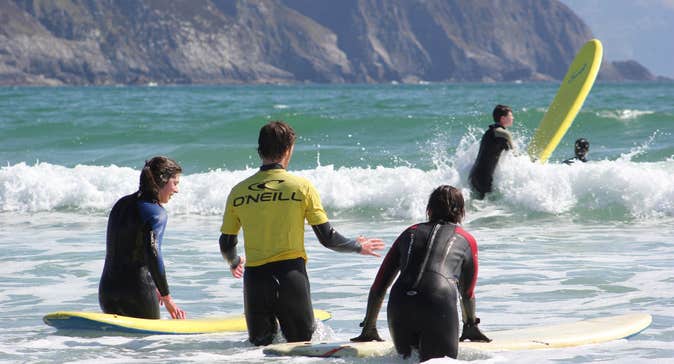 People surfing with their surf boards in the water