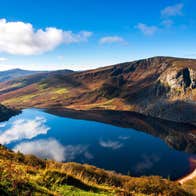A sunny day with some clouds reflected on Lough Tay, Wicklow Mountains National Park