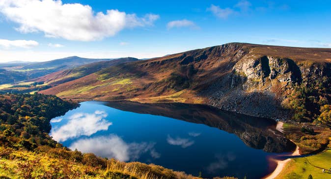 A sunny day with some clouds reflected on Lough Tay, Wicklow Mountains National Park