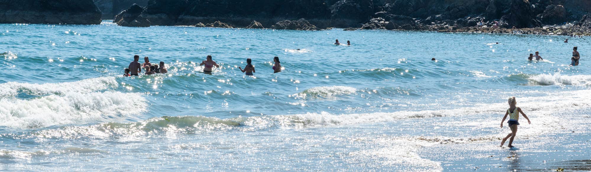 People swimming at Ballydowane Bay in County Waterford