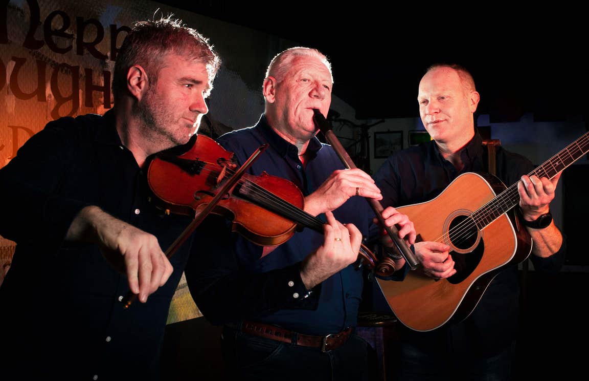 Group of three traditional Irish musicians playing at The Merry Ploughboy pub in Rathfarnham, Dublin.