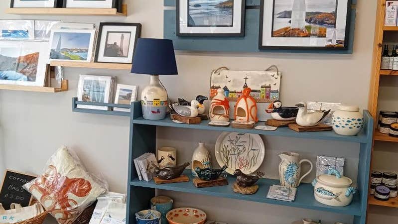 A shop floor display of local prints and pottery at West Cork Crafts
