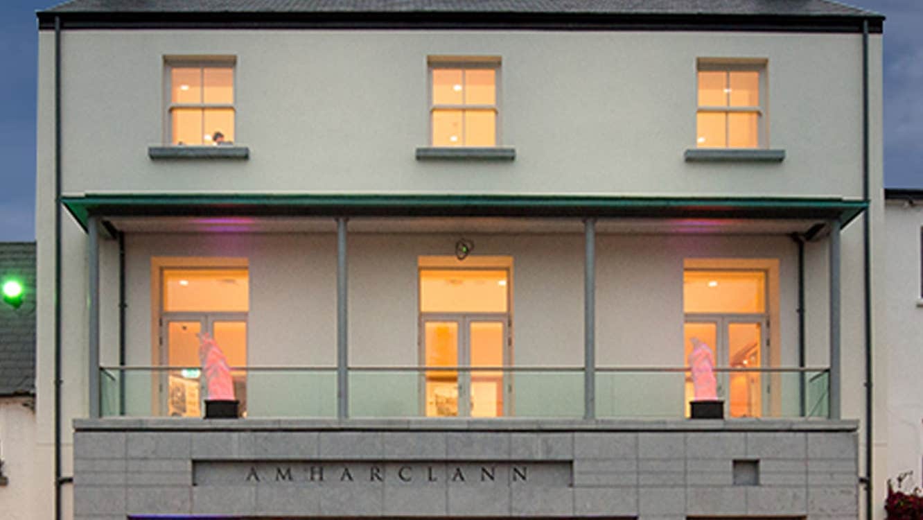 An exterior view of Westport Town Hall Theatre with people walking by outside