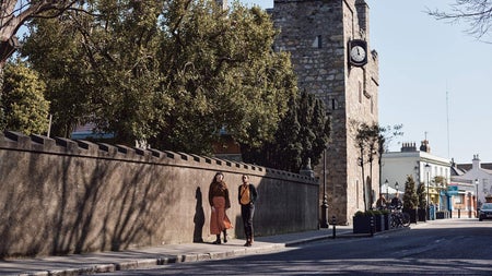 Two people walking on a footpath in Dalkey, Co Dublin