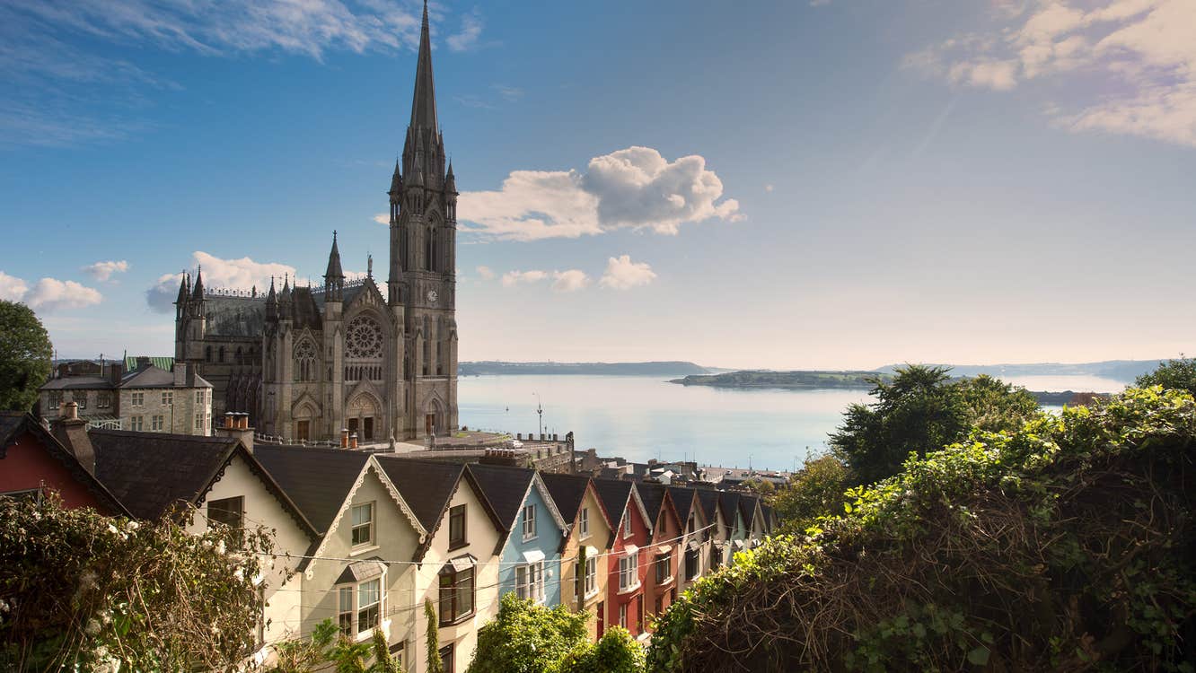St Colman's Cathedral beside a row of colourful houses