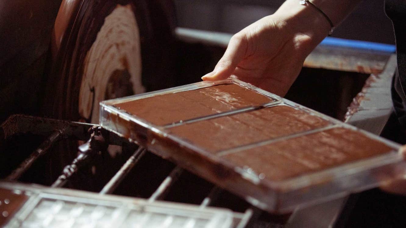 Someone holding a tray of freshly made chocolate bars