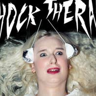 A shocked looking woman with white blonde hair