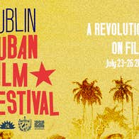In large navy and red writing, the DCFF logo appears on the left, then on the right it reads 'A revolution on film - July 23-25 2026'. It's a burnt yellow background with a faded version of the famous 1959 photo 'Camilo moving into Havana'