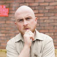 This Genuinely Did Happen - Ryan Carrick stands in front of a brick wall with a puzzled expression