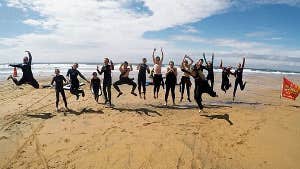 Group mid jump on the beach
