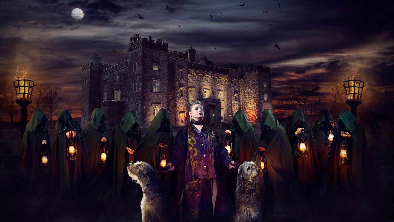 Actress Siobhán McSweeney standing outside of Slane Castle with Irish Wolfhounds and cloaked figures. (Image courtesy of RTÉ)