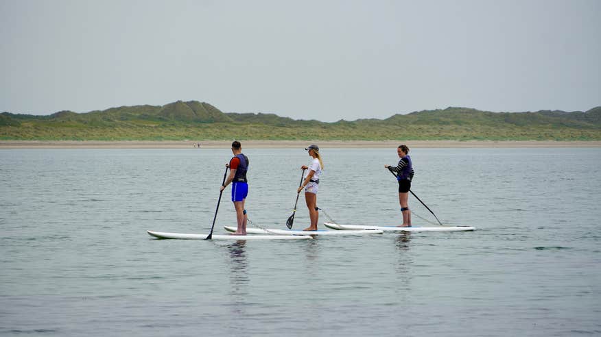 Three people SUPing in Enniscrone, County Sligo