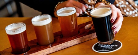 A tasting tray with four sample sizes of different beers