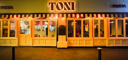 Image of TONI Italian restaurant in the evening with the outside lighting on