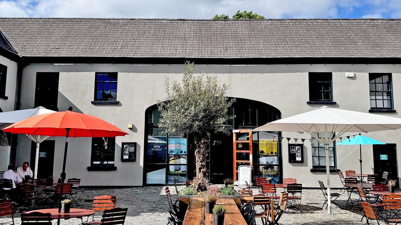Phoenix Park Café exterior courtyard with table and umbrellas