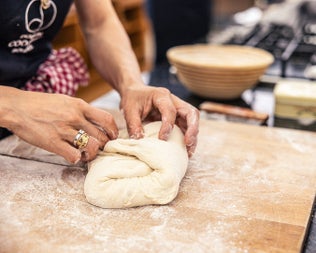 Dough being kneaded on a board