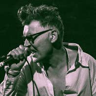 A man singing into a mic he's holding