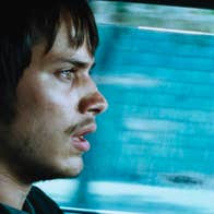 A worried man driving a car.