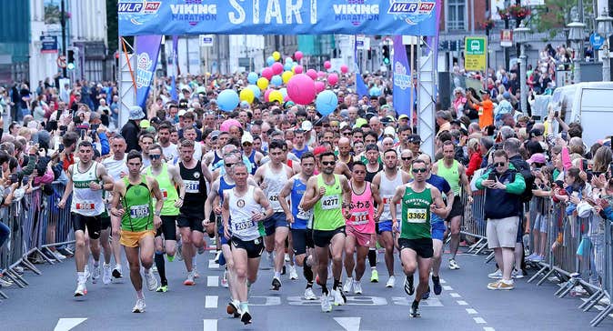Waterford Viking Marathon 2026, lots of people running at the start of a marathon in a city.