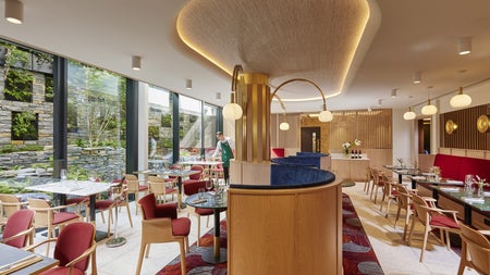 Red and wooden restaurant interior with tables and chairs on either side
