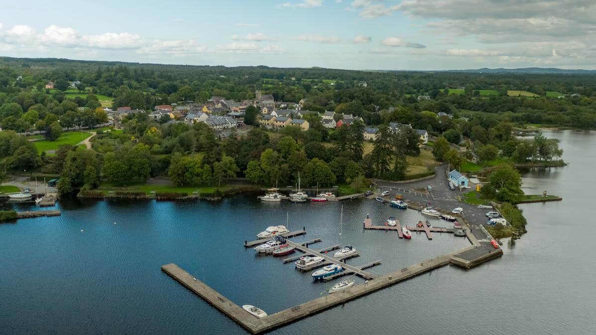 Aerial view of boats in a harbour with a town in the background