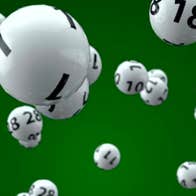 Lottery balls against a green background.