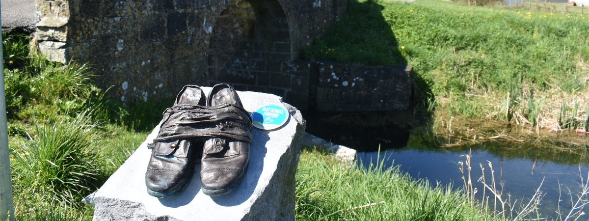 Bronze shoes sculpture along a walking route