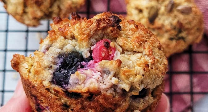 A hand holding a fruit scone