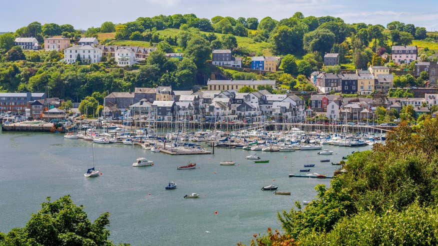 Boats in the water in front of houses in Kinsale Harbour in West Cork