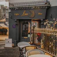 Café entrance with outdoor seating area overlooking Trim Castle