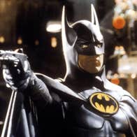 Batman pointing a firearm of some kind.