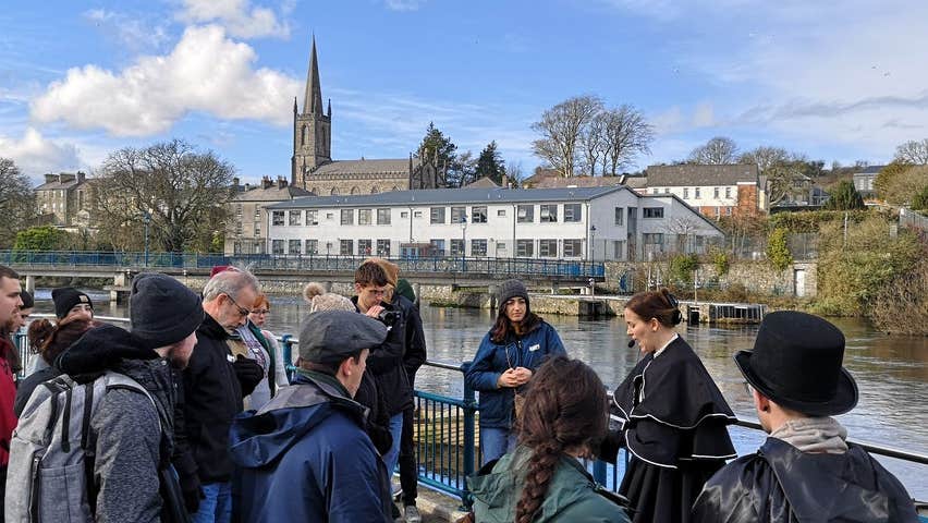 A group of people led by a guide in costume on the Sligo Dark Tales Tour